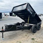 a dump trailer is parked on the side of the road