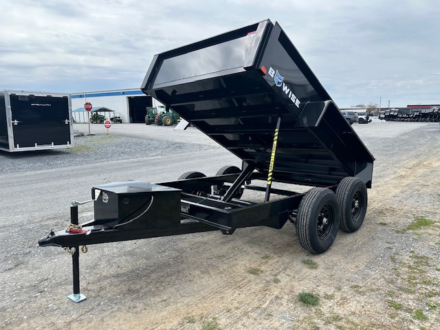 a dump trailer is parked on the side of the road