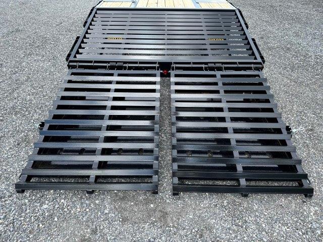 a black metal ramp is sitting on top of a gravel road .