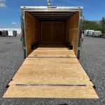 the back of a trailer with the door open and a wooden floor .