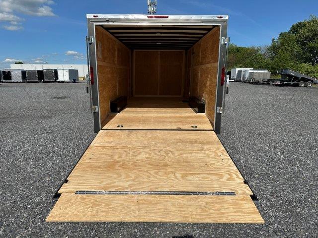 the back of a trailer with the door open and a wooden floor .