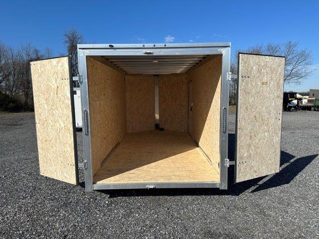 the inside of an empty trailer with the doors open .