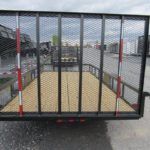 a trailer is parked on the side of the road in a parking lot .