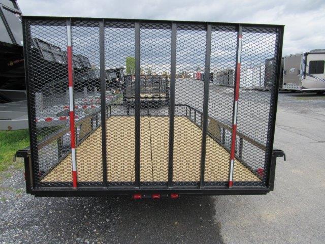 a trailer is parked on the side of the road in a parking lot .