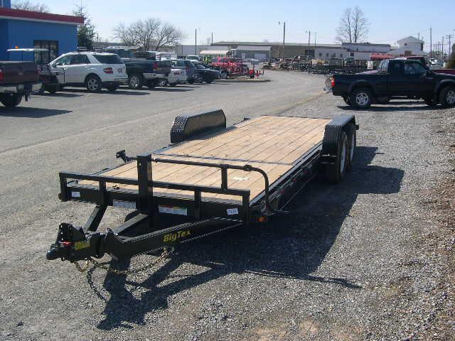 a trailer is parked on the side of the road in a parking lot .