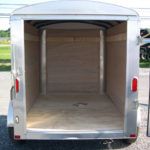 the inside of an empty small cargo trailer with the door open