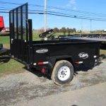 a black trailer is parked in a parking lot