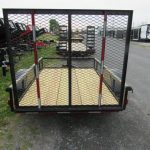 a trailer is parked on the side of the road in a parking lot .