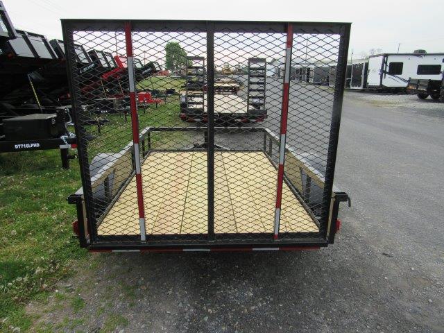 a trailer is parked on the side of the road in a parking lot .