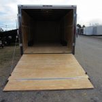 a trailer with a wooden floor is sitting on the side of a road