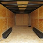 the inside of an empty trailer with a wooden floor .