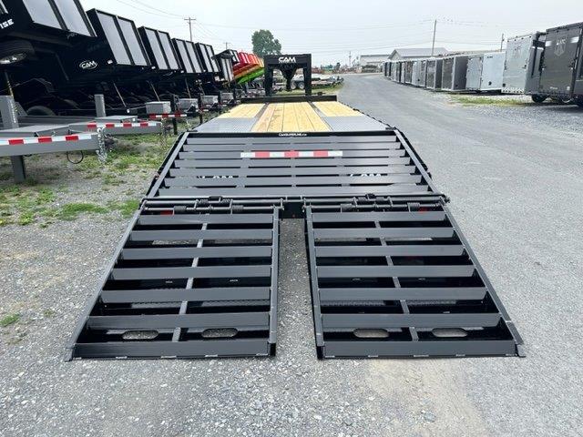 a trailer with ramps attached to it is parked in a parking lot