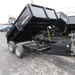 a dump trailer is parked in a parking lot