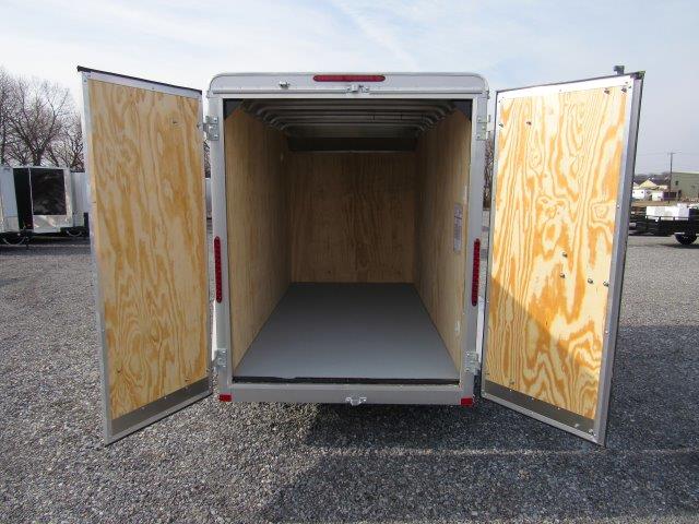 the inside of an empty trailer with the doors open .