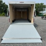 the inside of a trailer with the door open is sitting in a gravel lot