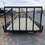 a trailer is parked on the side of the road in a parking lot .