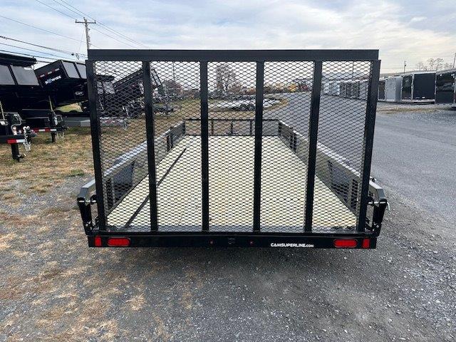 a trailer is parked on the side of the road in a parking lot .