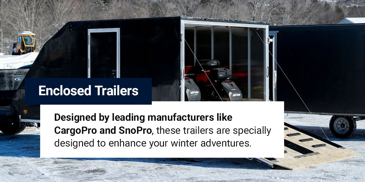 An enclosed trailer with two snowmobiles inside