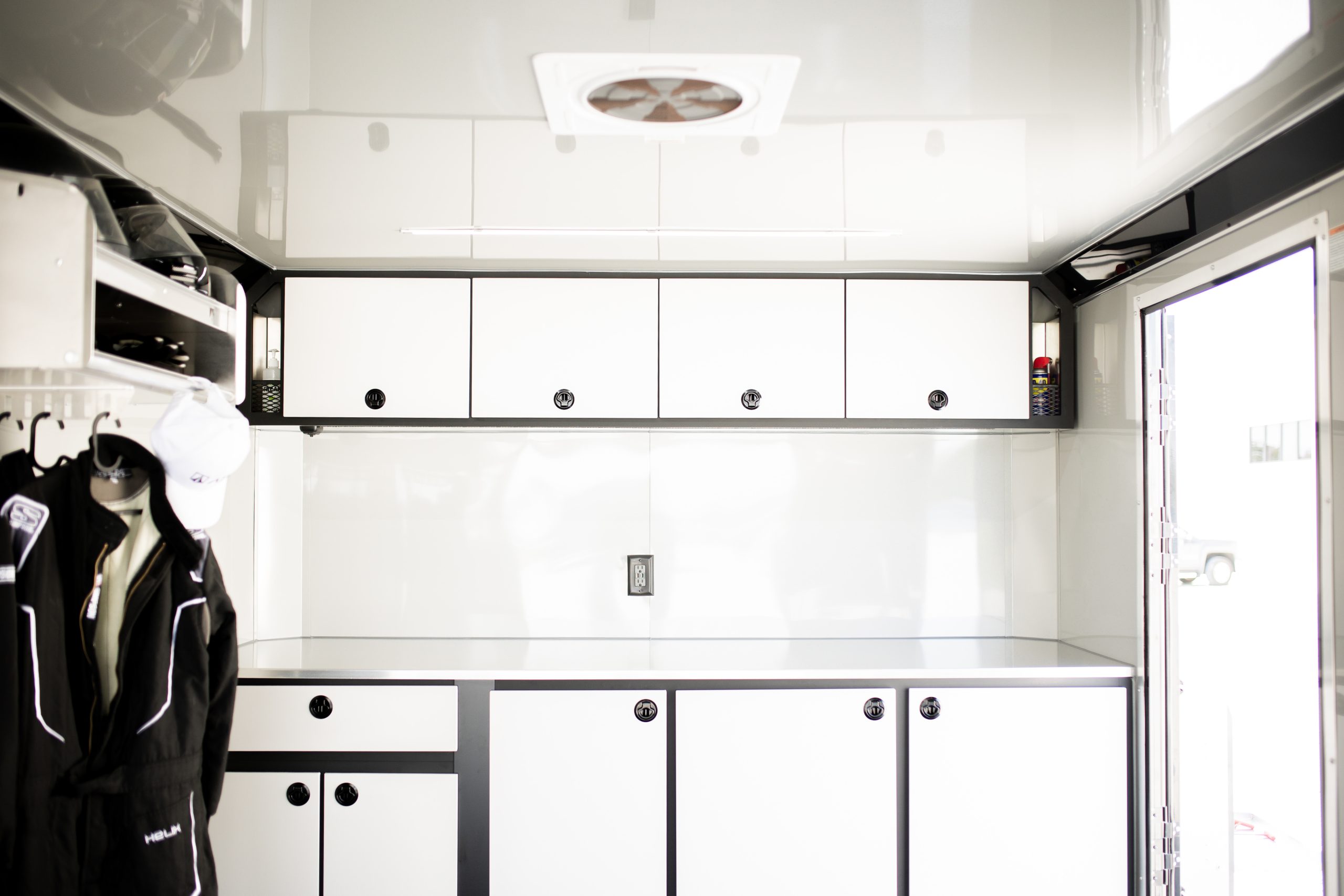 White cabinets inside of a custom trailer